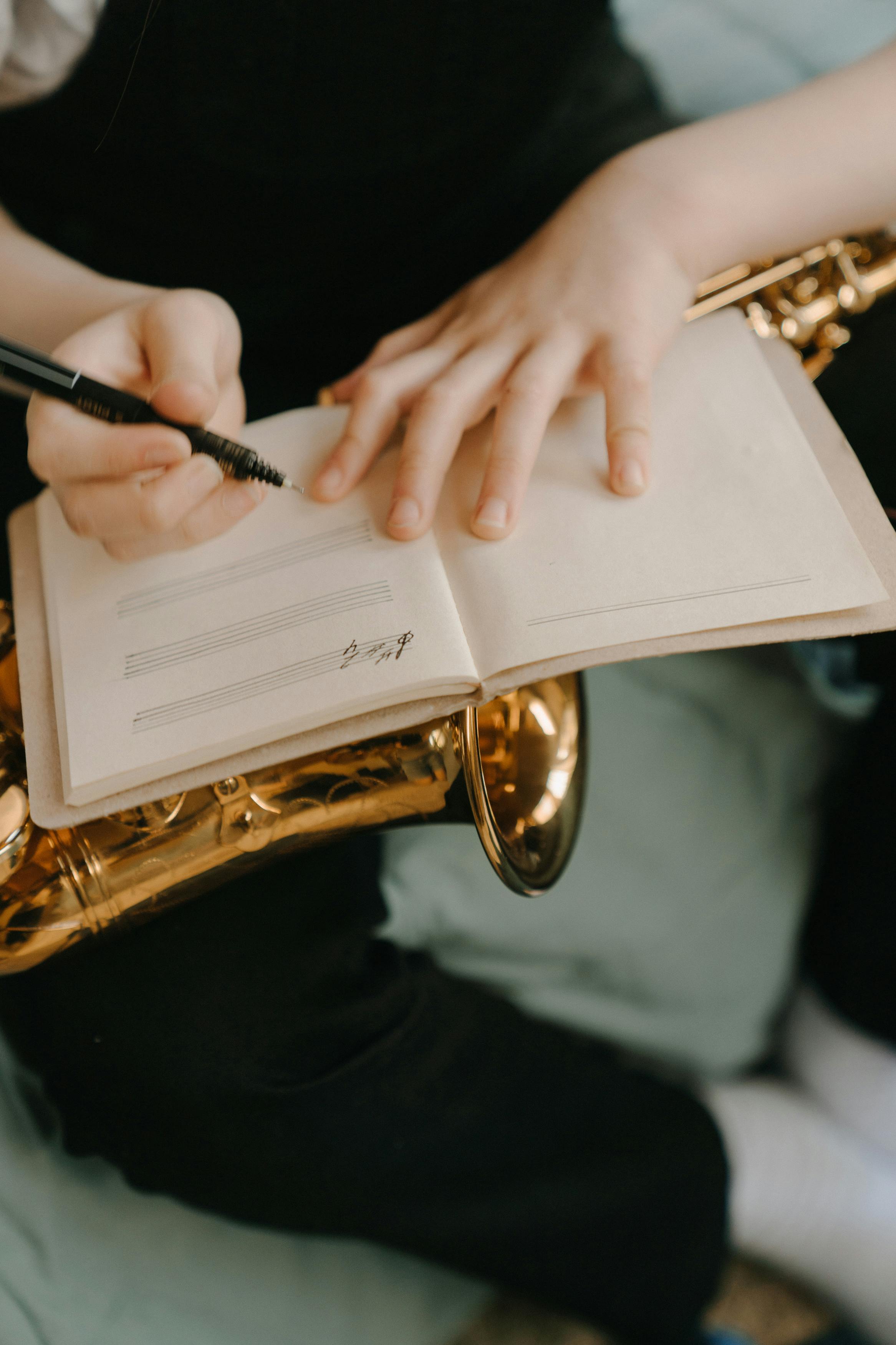 person holding black pen on white book page