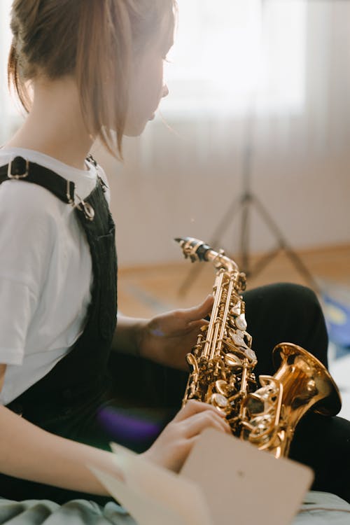 Woman in White Shirt Playing Saxophone