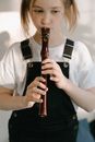 Woman in White Shirt Holding Flute