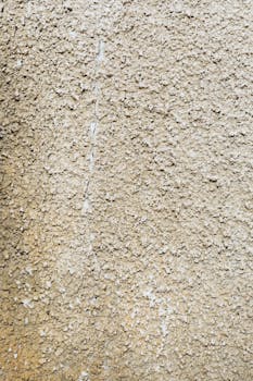 Close-up of a textured concrete wall with rough surface patterns.