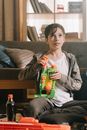 Boy in Gray Long Sleeve Shirt Holding Green Plastic Bottle