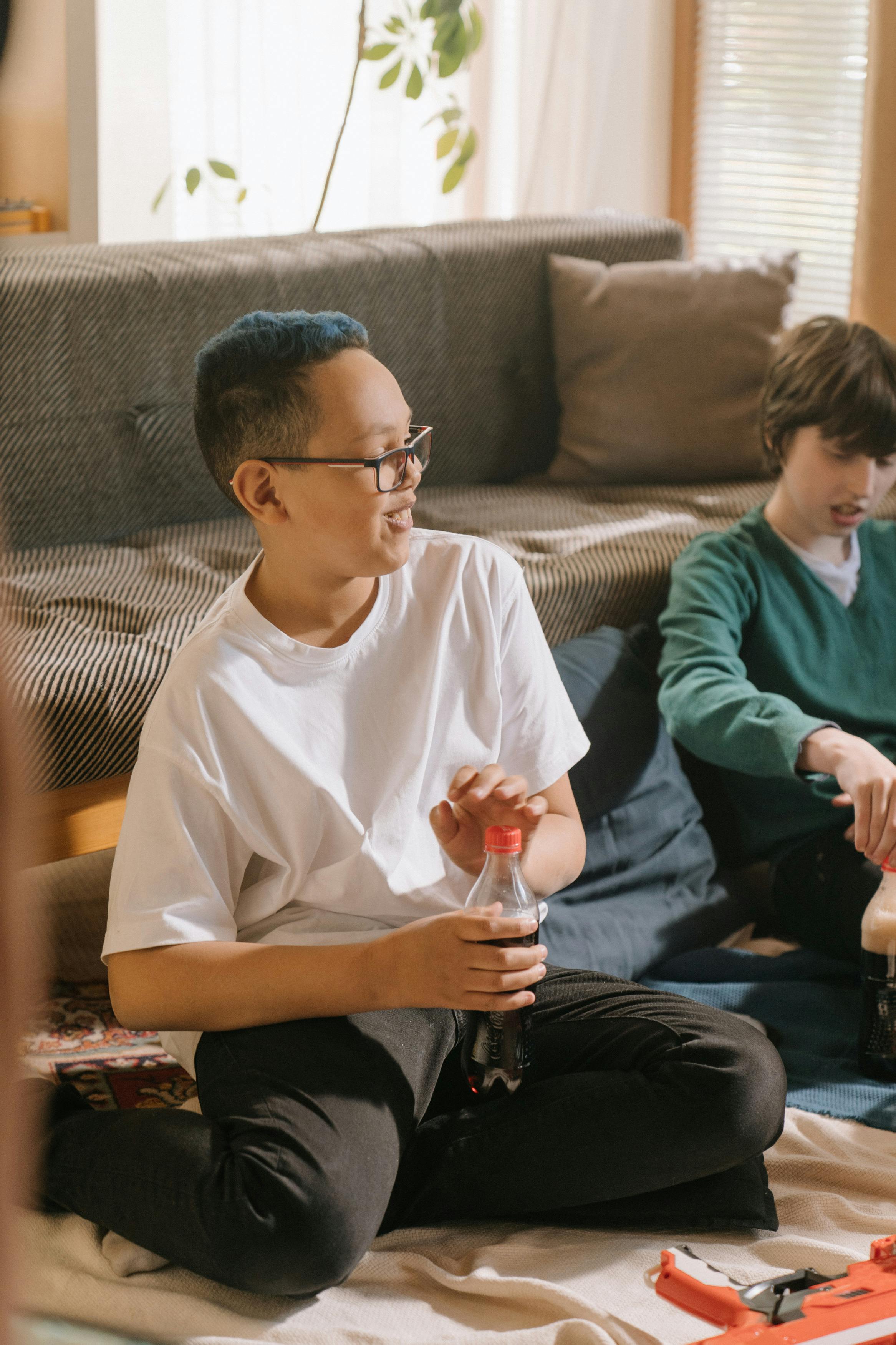 man in white crew neck t shirt sitting on couch