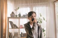 Woman in Gray Hoodie Holding Black Smartphone