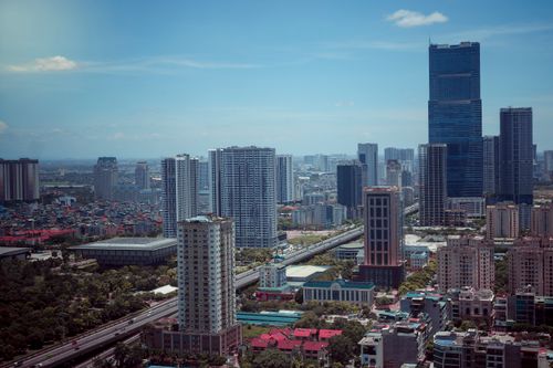 Free From above of contemporary apartment buildings with modern skyscrapers located in middle of city against blue sky in summer day Stock Photo