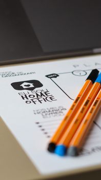 Close-up of pencils on a planner with 'Home Office' text for organization and productivity.