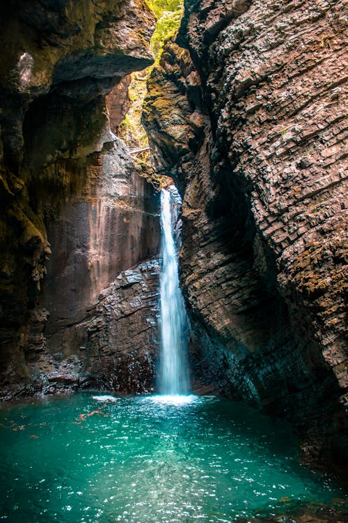 Water Falls on Brown Rocky Mountain