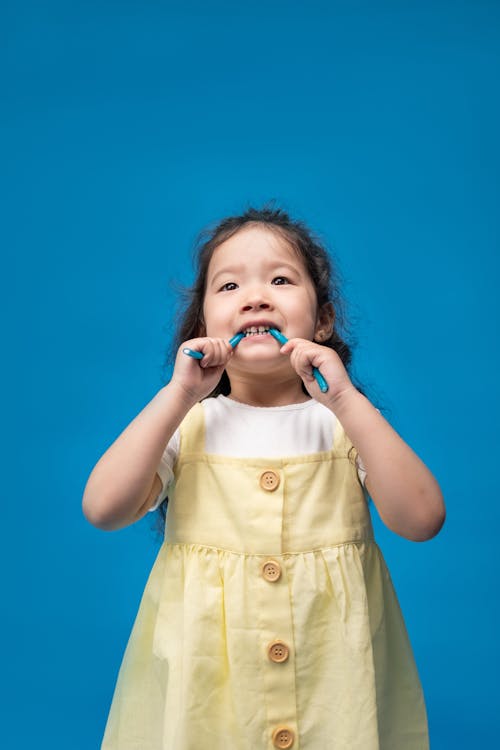 Free Girl in Yellow Button Up Shirt Holding Microphone Stock Photo