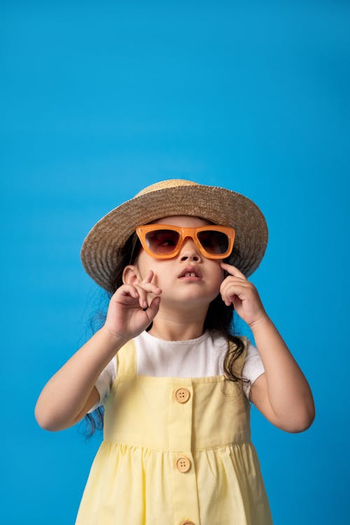 Free Woman in White Button Up Shirt Wearing Brown Sun Hat and Sunglasses Stock Photo