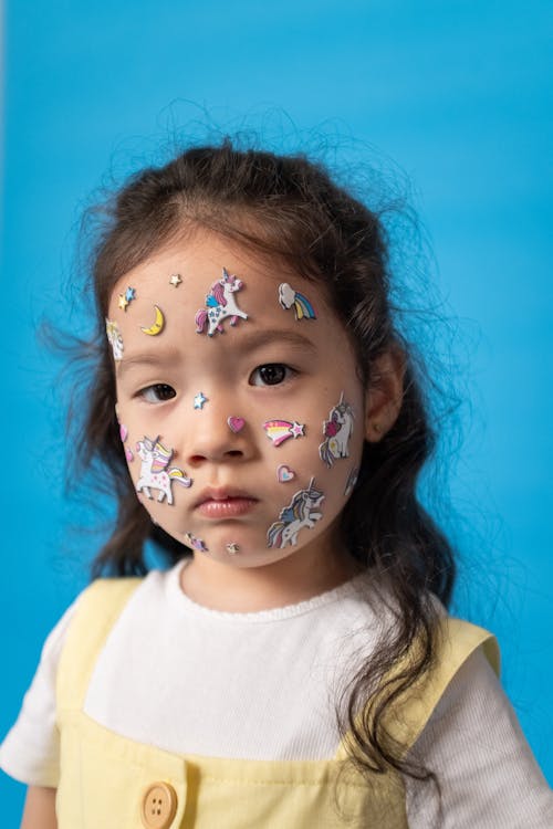 Free Girl With Face Paint Wearing White Crew Neck Shirt Stock Photo