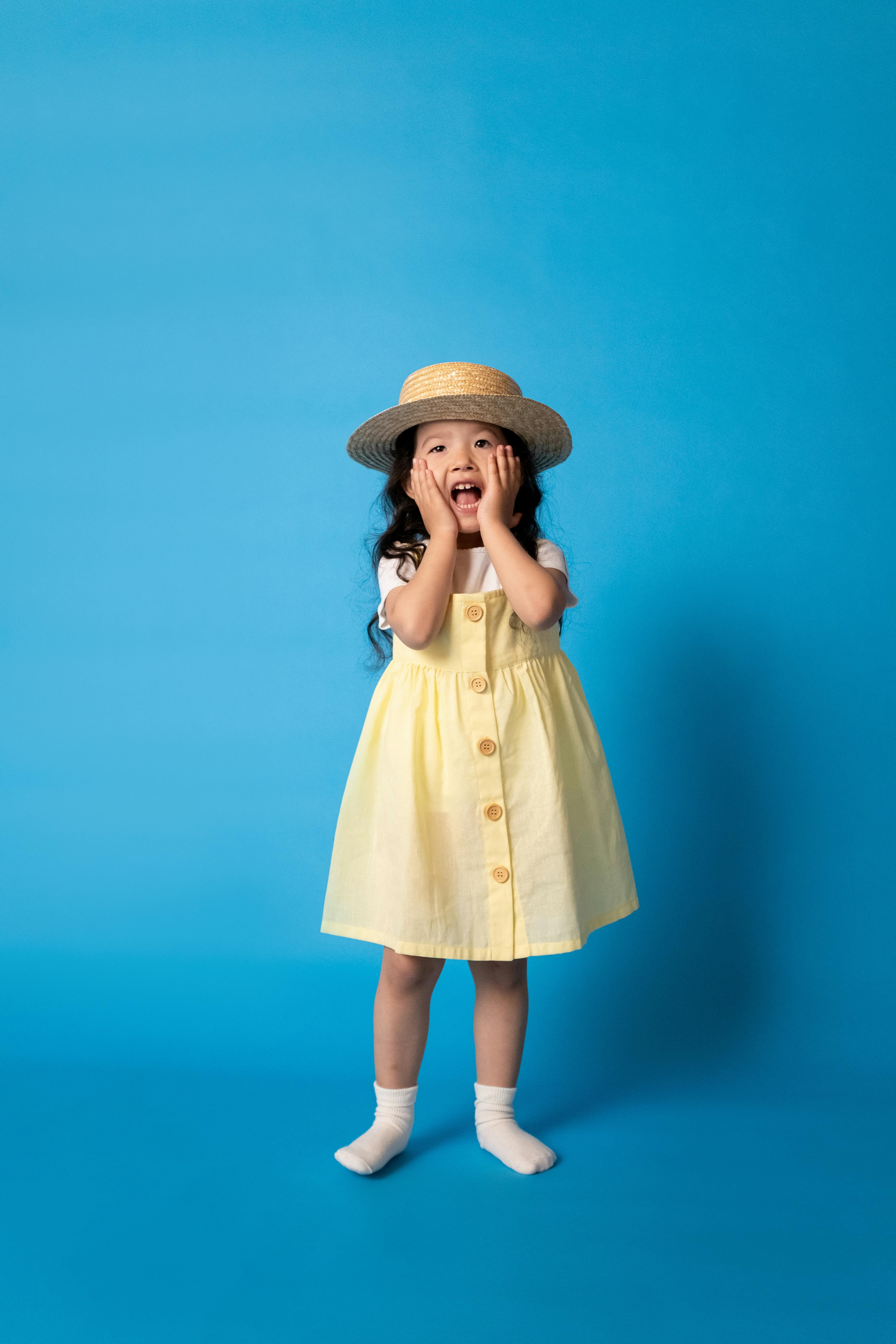 woman in brown dress wearing brown hat