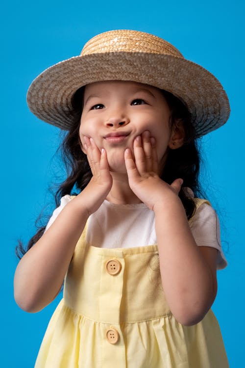 Girl in White Button Up Shirt Wearing Brown Hat