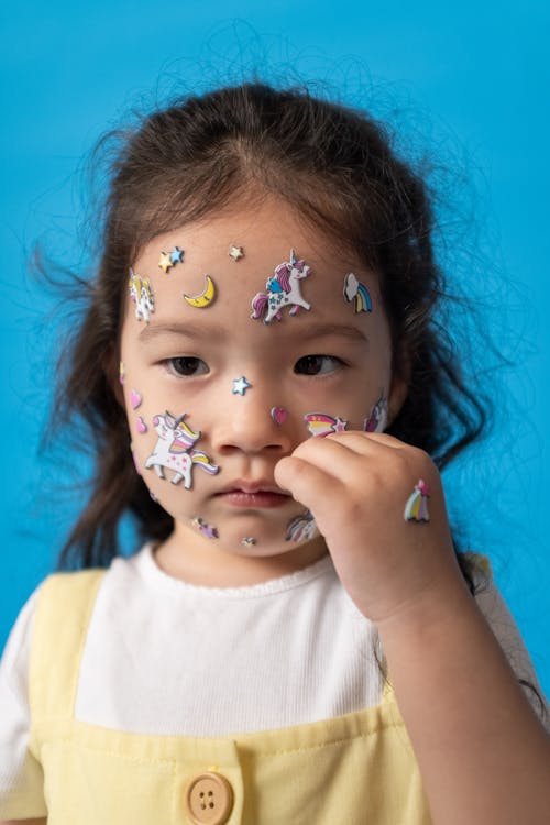 Girl in White Crew Neck Shirt With Face Paint