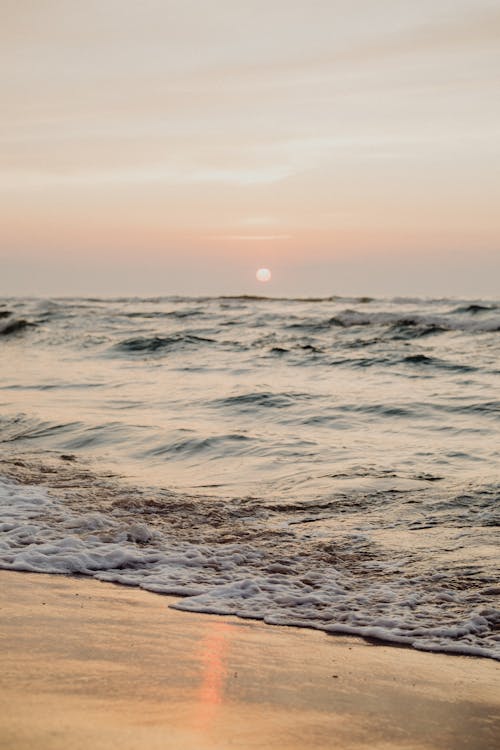 Ocean Waves Crashing on Shore during Sunset