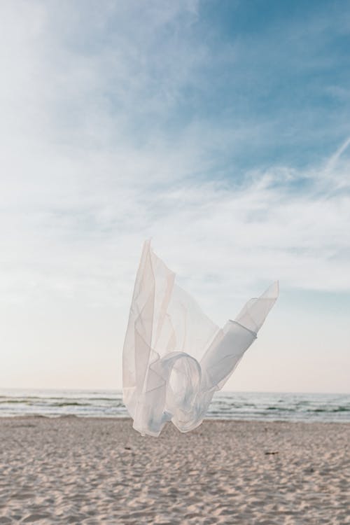 White Sheer Fabric Blown by Wind Over the Seashore