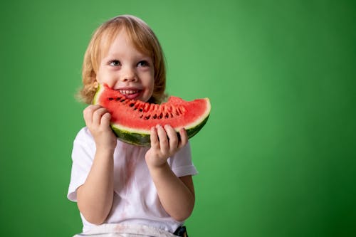 Girl in White Shirt Holding Green Watermelon