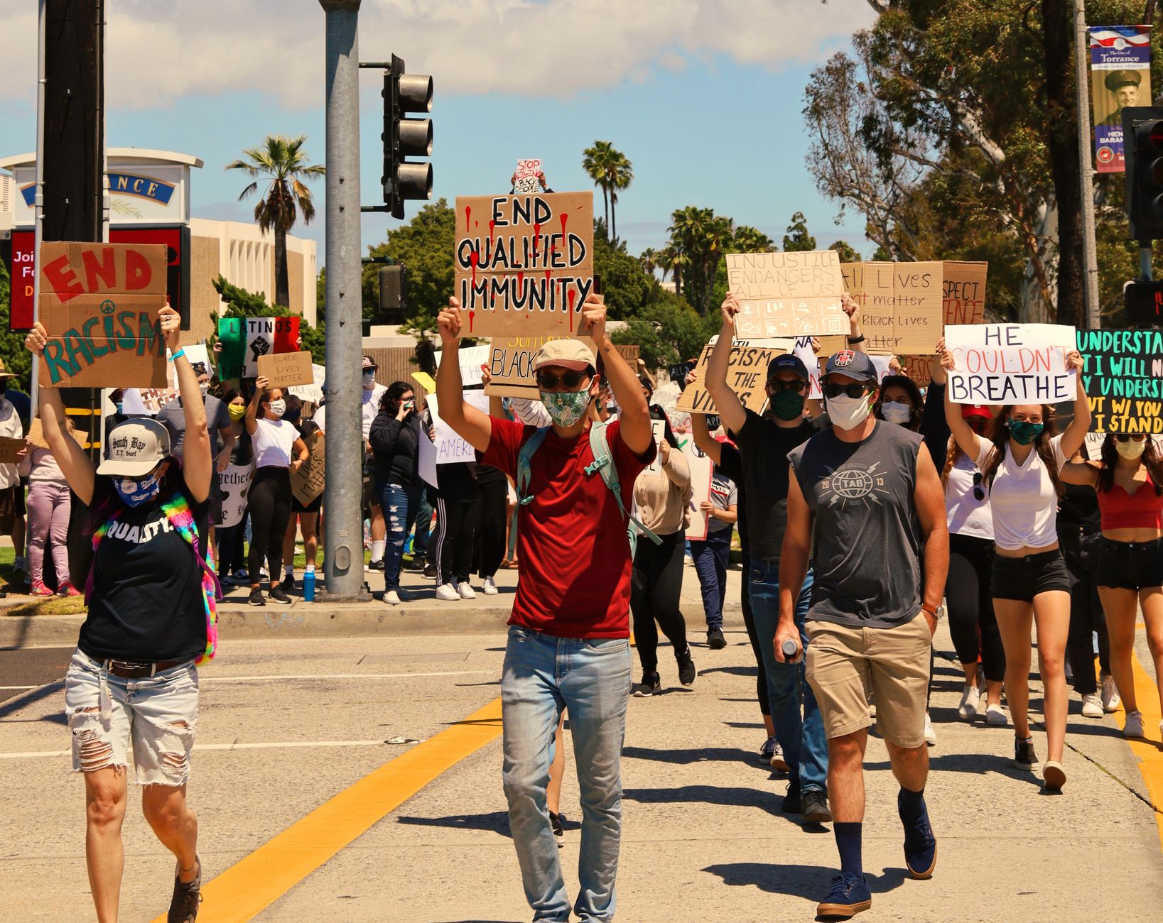 supporters walking through Los Angeles fan celebrations near Exposition Park during a bright summer afternoon