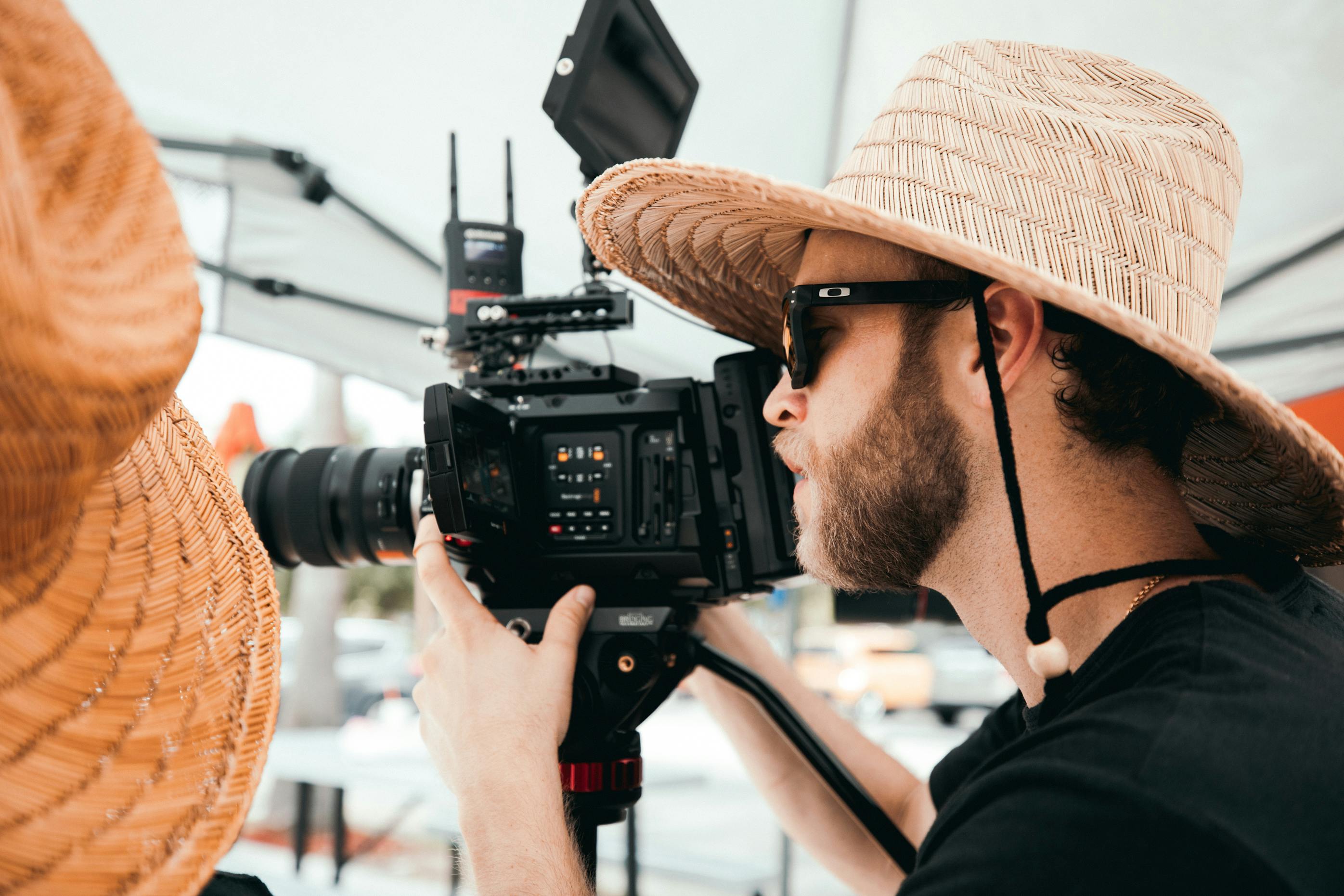 man in black shirt holding black camera