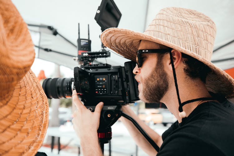 Man In Black Shirt Holding Black Camera