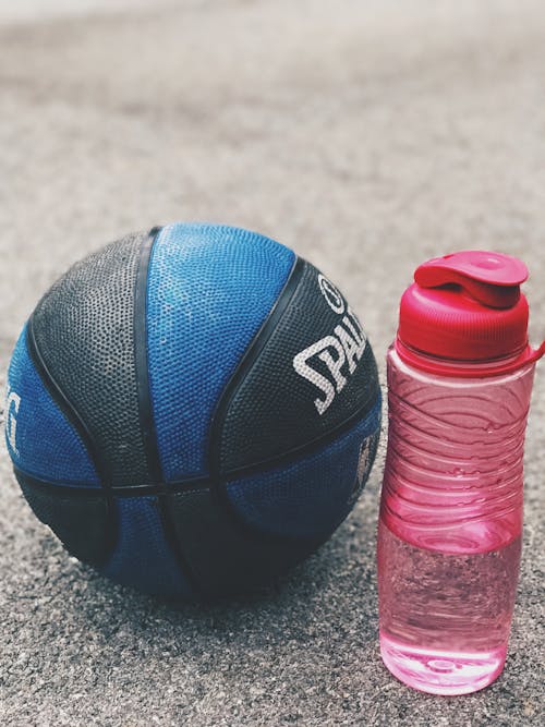 Photo of Basketball Near Pink Water Bottle