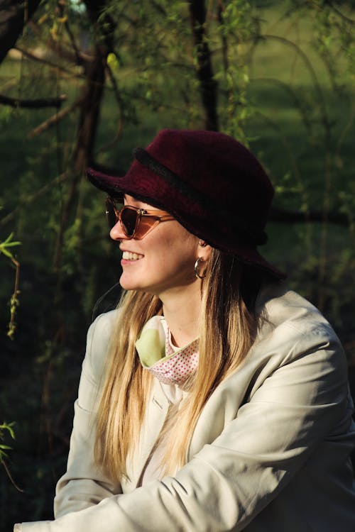 Woman in White Coat Wearing Maroon Hat