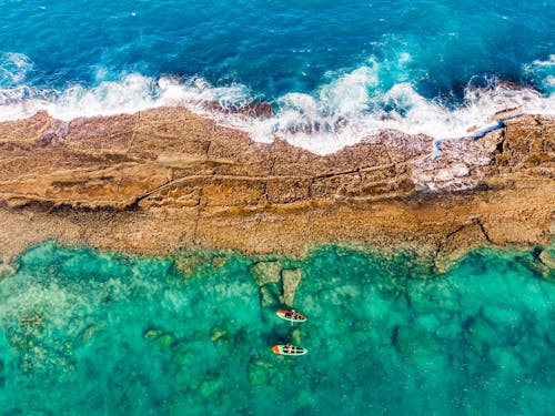 Aerial View of Person Paddleboarding on Sea