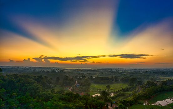 A breathtaking aerial view of sunset over lush farmland in Rumpin, West Java, Indonesia.