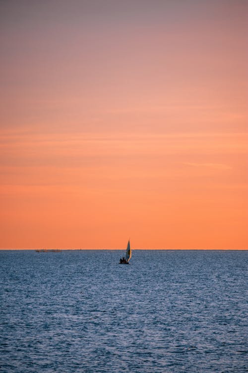 Sailboat on Sea during Sunset