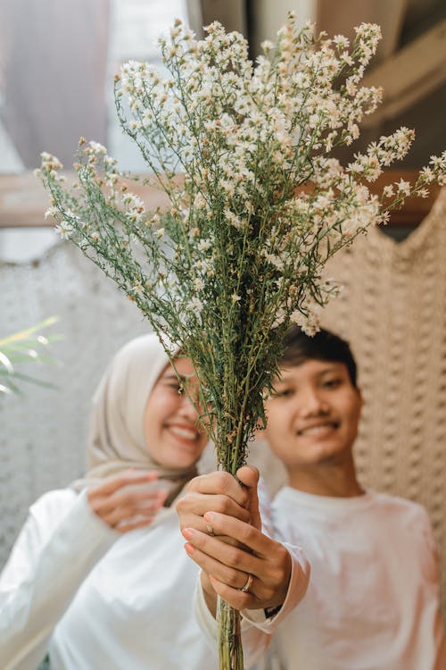 Free A Couple Holding Bouquet of Flowers Stock Photo