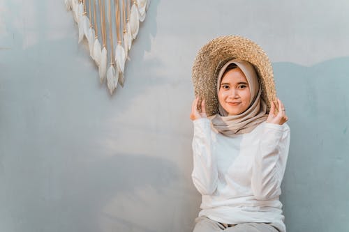 Free Photo of Woman in White Long Sleeve Shirt and Brown Hijab Smiling Stock Photo