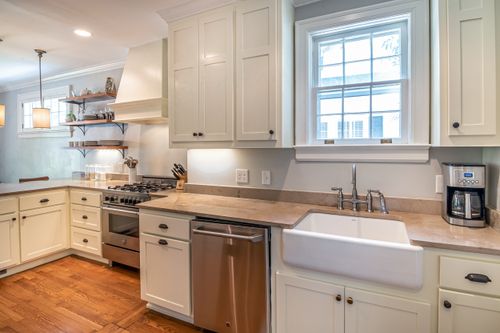 Free Bright kitchen with wooden floors and modern white cabinetry. Stock Photo