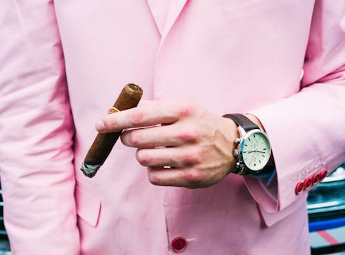 Person in Pink Suit Jacket Wearing Silver Round Chronograph Watch