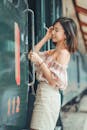 Woman Fixing Her Hair While Entering a Train