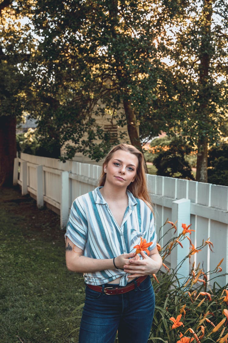 Woman Wearing Striped Shirt Standing On The Backyard