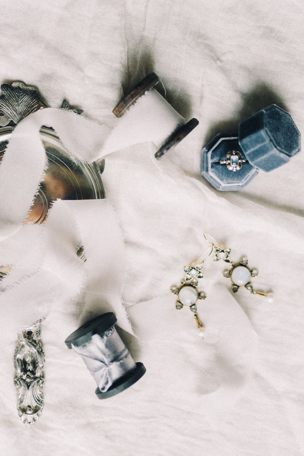 Elegant jewelry displayed on soft satin fabric beside a jewelry box
