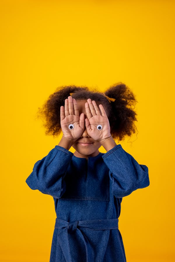 Woman in Blue Long Sleeve Shirt Covering Her Face With Her Hair