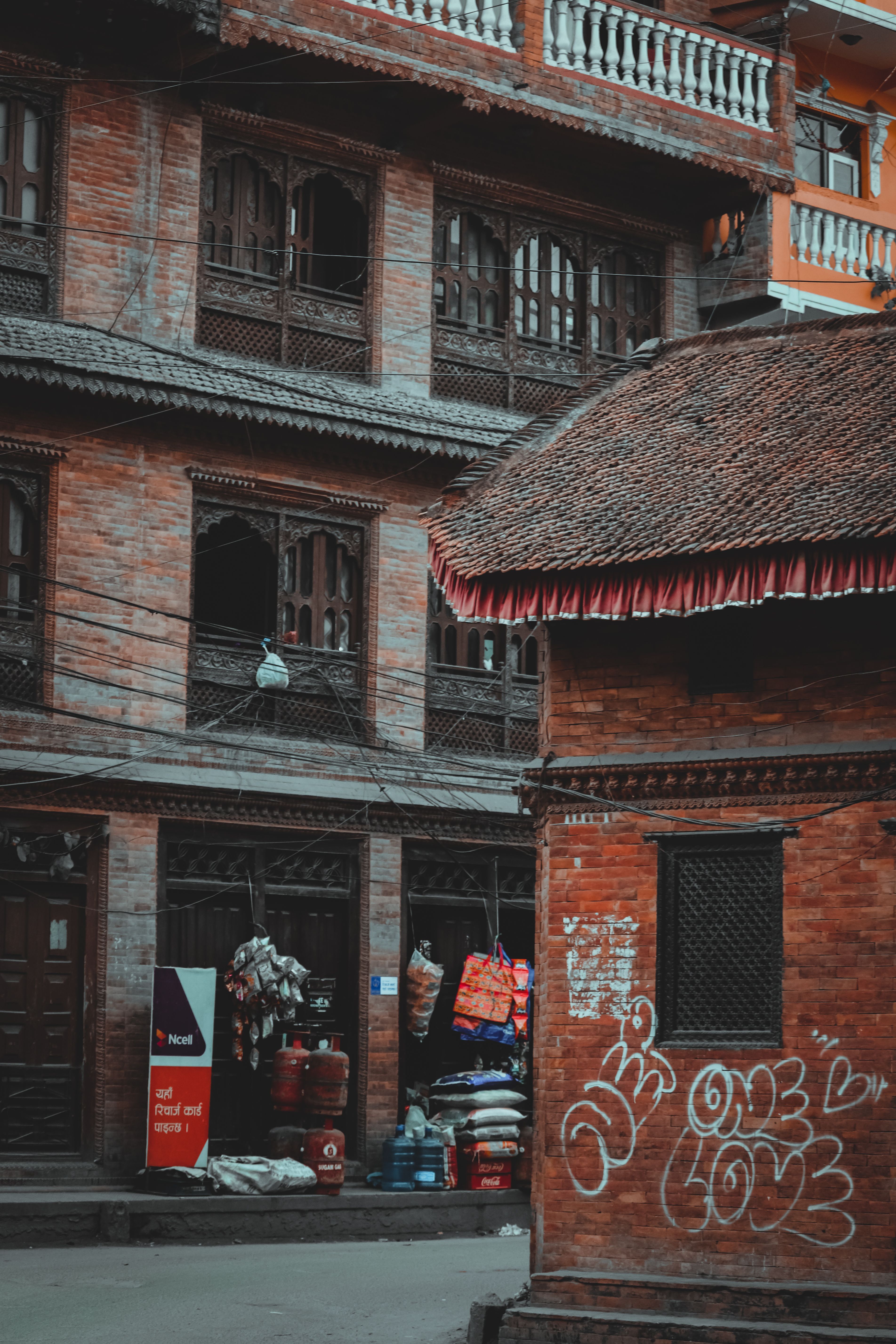 Traditional brick architecture with street merchandise in Kathmandu, Nepal.