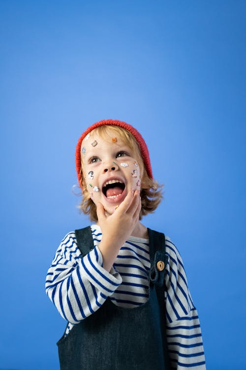 Girl in Black and White Stripe Shirt With Red Hat