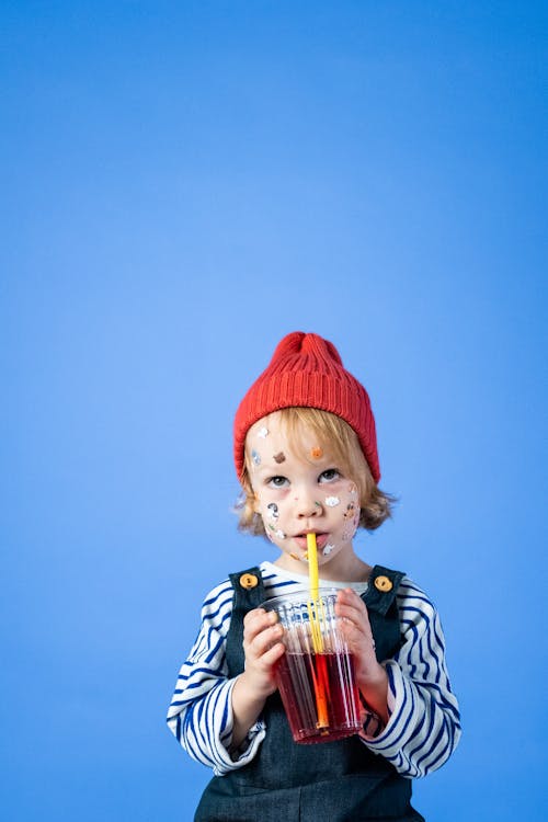 Free Girl in Red Knit Cap and Black and White Stripe Shirt Stock Photo