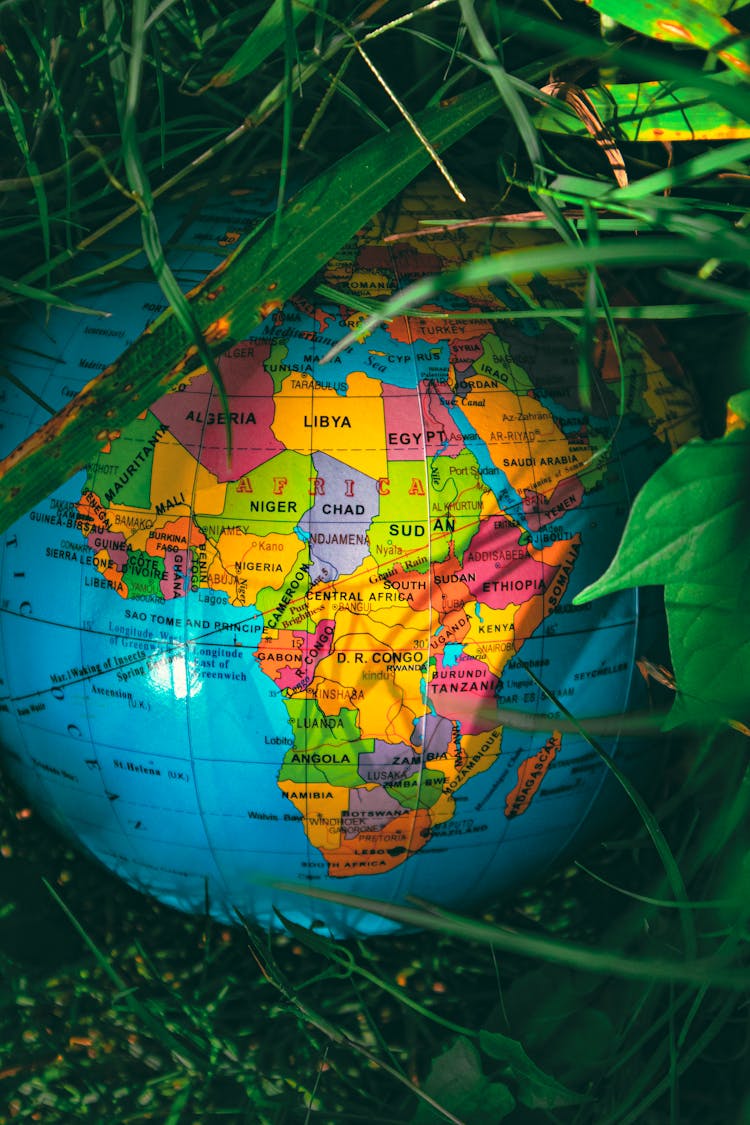 Globe With Colorful Map Placed On Grass In Park