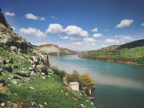 Explore the serene landscape of Ana, Iraq with lush greenery and a tranquil river.
