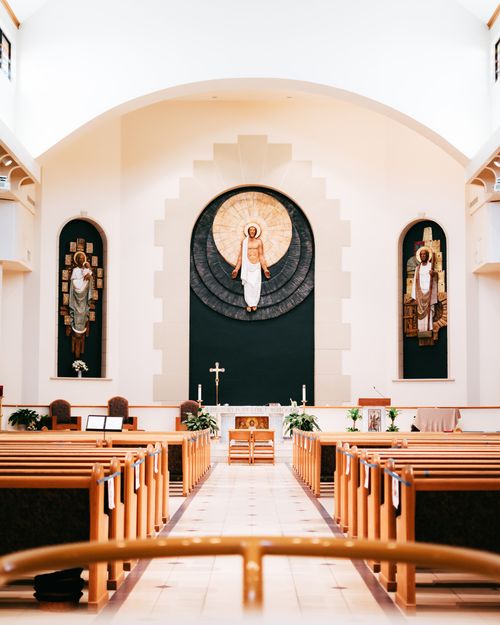 Free Captivating view of a beautifully crafted Catholic church interior featuring an altar and religious icons. Stock Photo