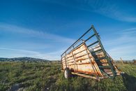 Abandoned trailer in field near mountain valley