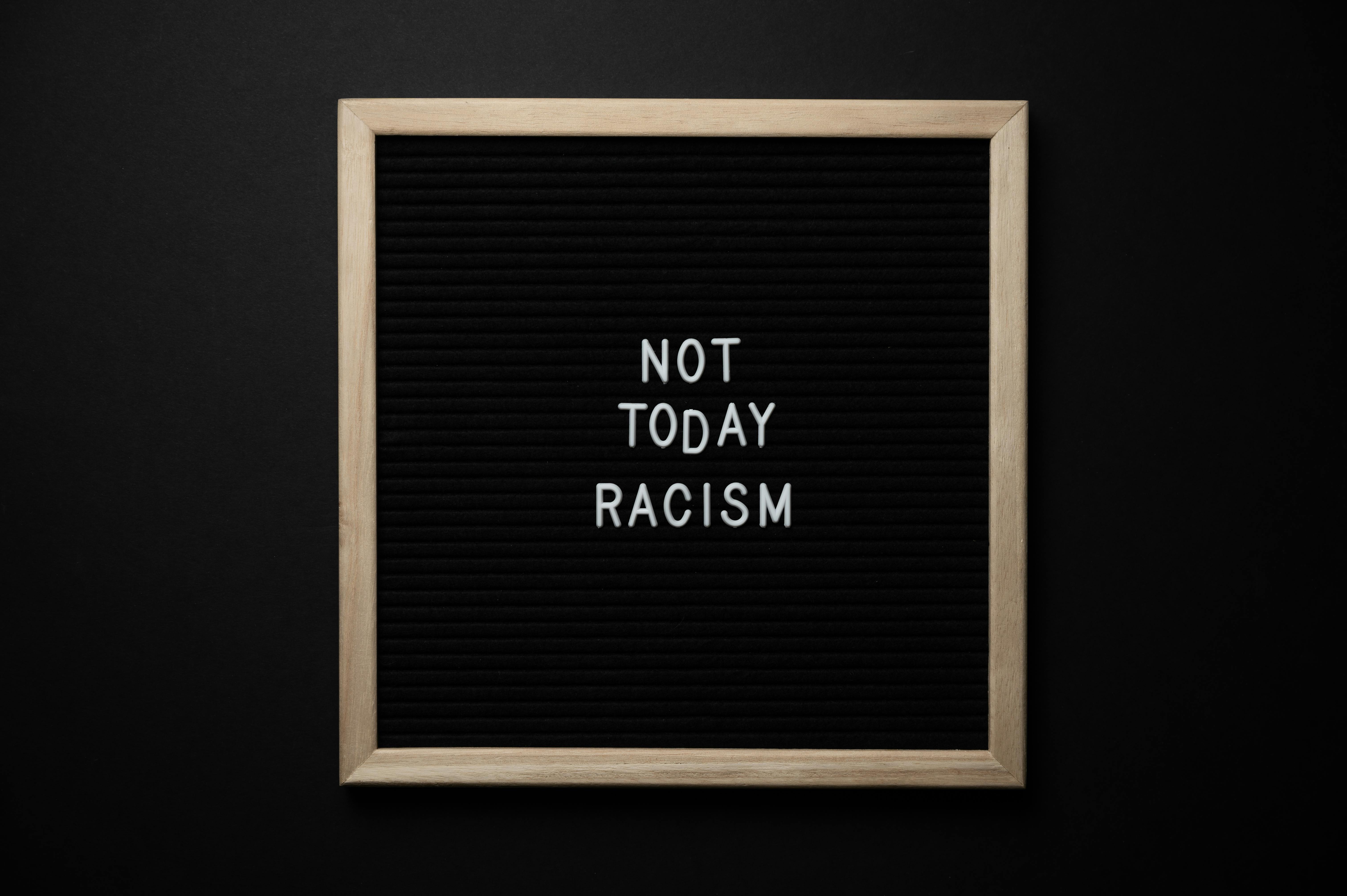 slogan not today racism on black signboard