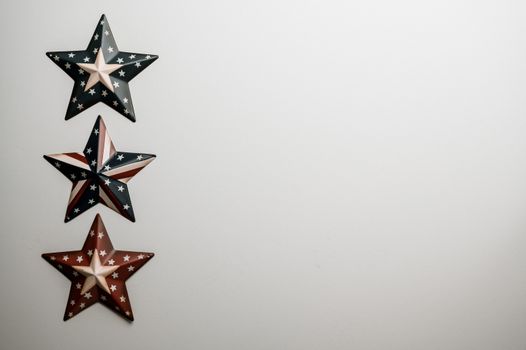 Top view of image of Flag of United Stated on surface of raised army stars on grey background