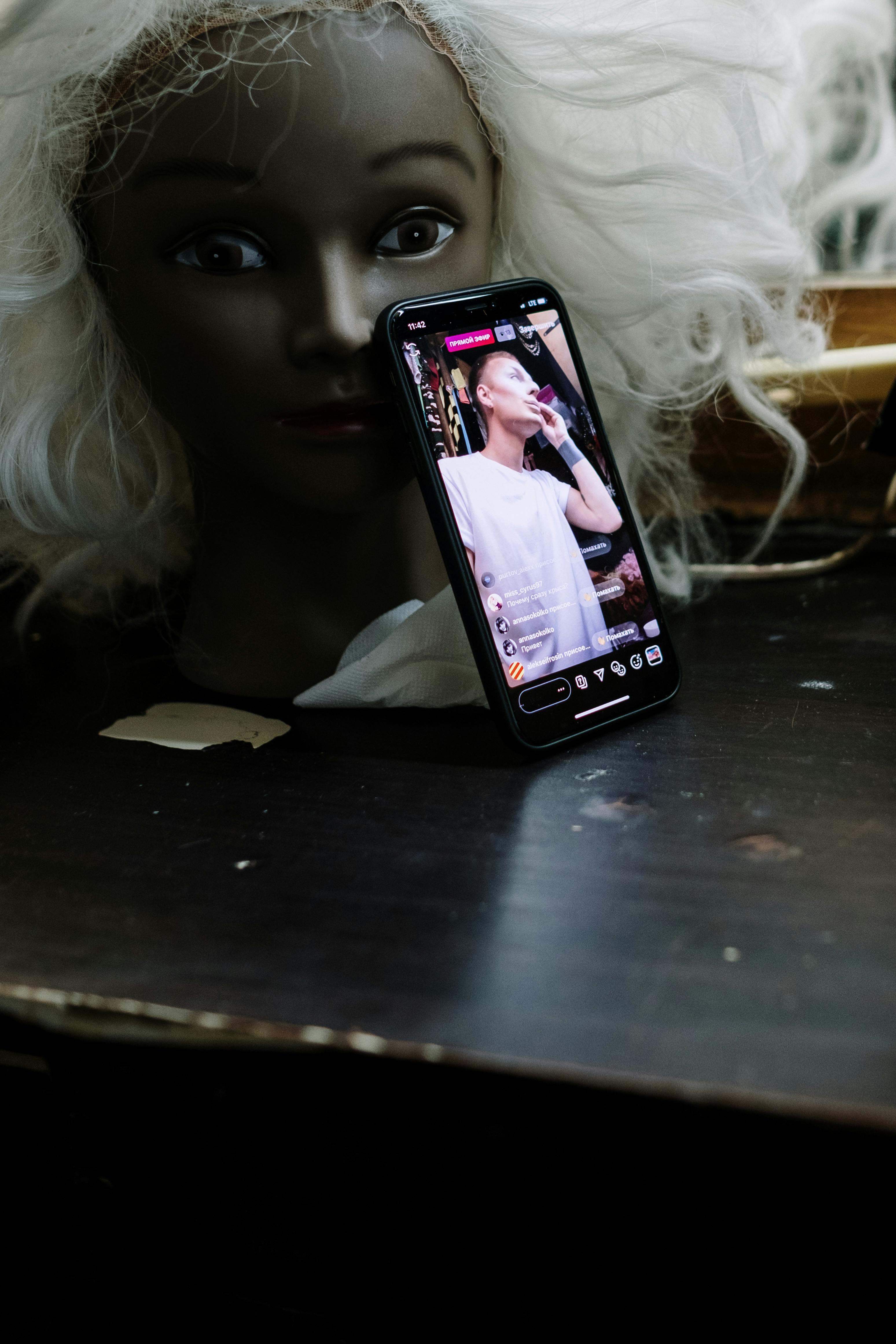 black smartphone on wooden table