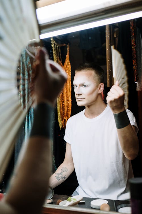 Drag Queen Holding Fan in Dressing Room