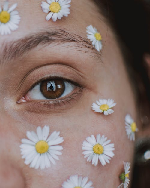 Close-Up Shot of a Woman's Face with Flowers