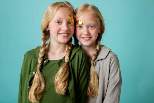 2 Smiling Girl Wearing Green Shirt and Gray Blazer