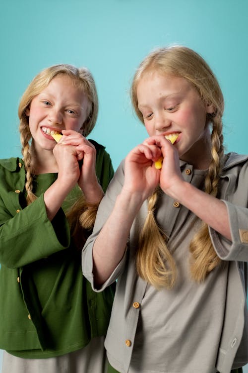 Girl in Green Jacket Eating Food