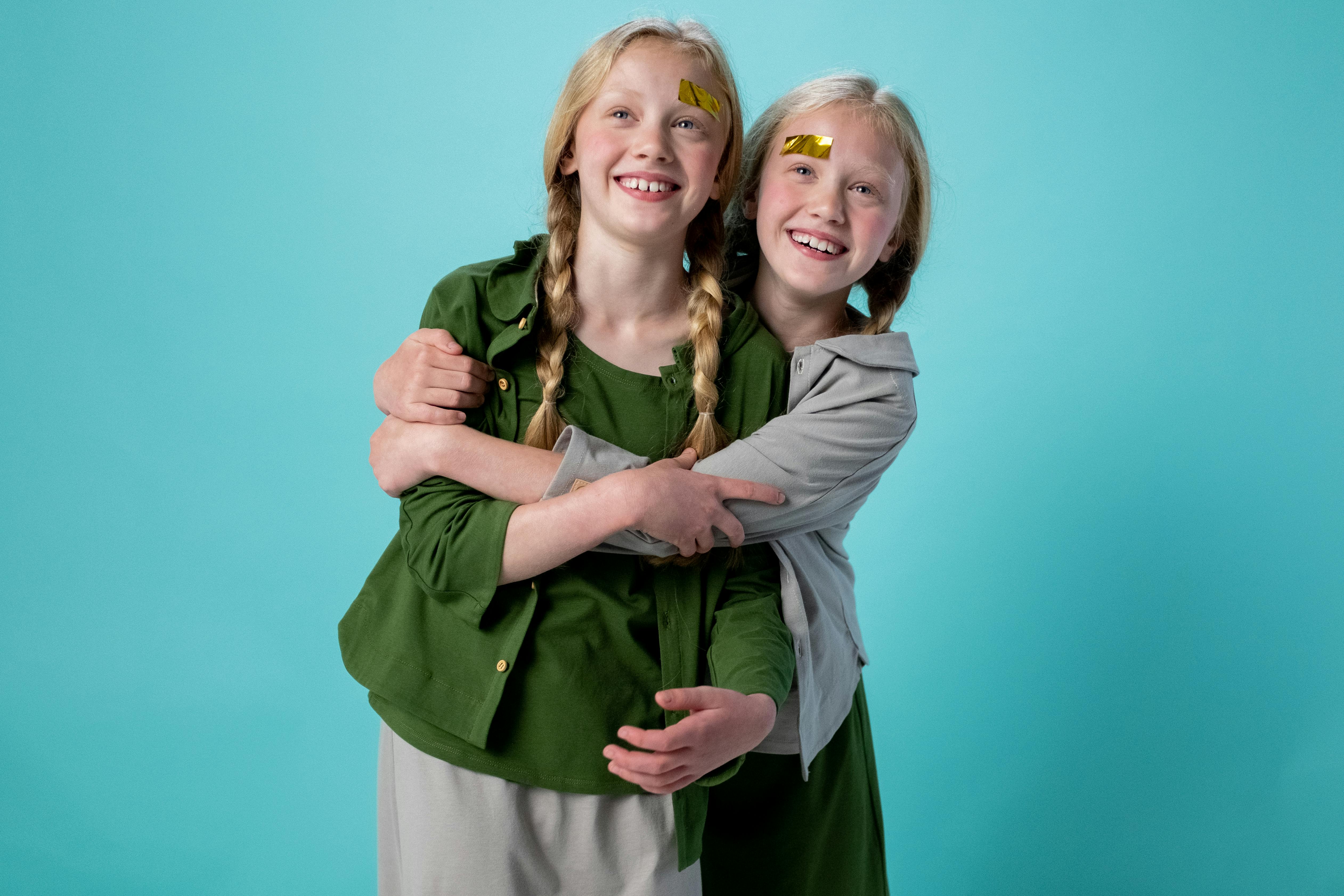 2 smiling women standing side by side